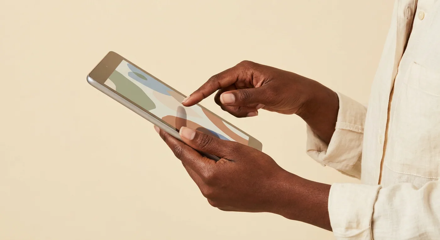 Hands of a doctor reviewing a patient case on a tablet.